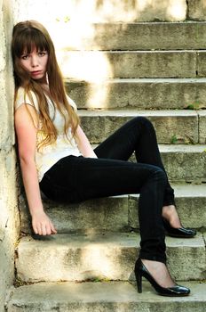 sad lonely girl sitting on the stairs