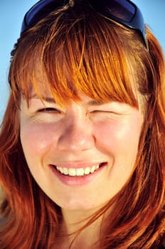sun shining  on a face of redheaded girl
