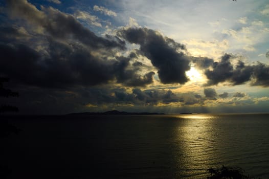 The sun breaking through the clouds over the sea