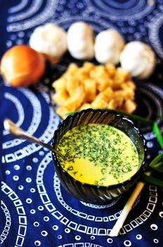 Pumpkin cream soup with cream  in a bowl (selective focus)