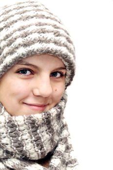 pretty teenage  girl wearing wool hat and scarf over the white (focus on the left eye)