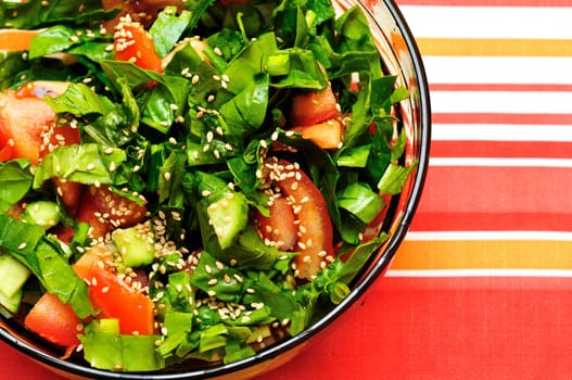 fresh salad made from tomatos,  spinach,  bunch-onion,  cucumbers and  sesame