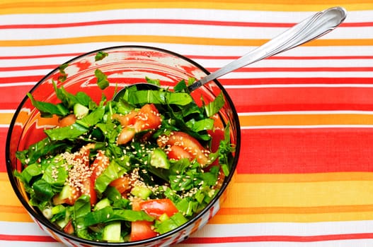 fresh salad made from tomatoes, spinach, bunch-onion, cucumbers and sesame
