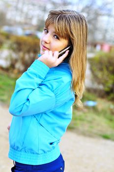Beautiful teenager girl talking by cellular phone.
