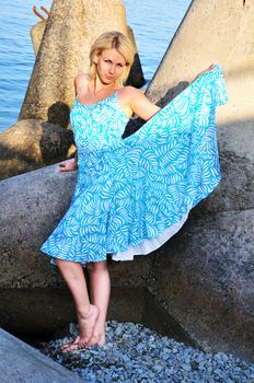 Pretty girl in blue dress on the beach
