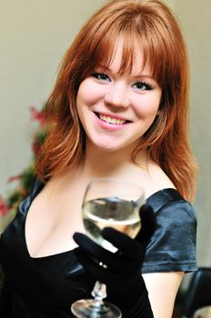 beautiful redheaded girl with glass of wine