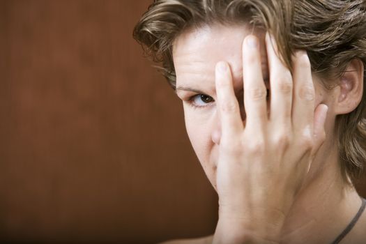 Portrait of a shy woman hiding her face