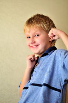 boy making fists and smiling (soft focus)