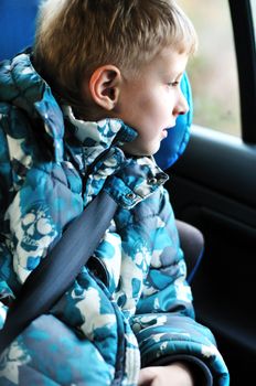 boy in carseat looking in the window