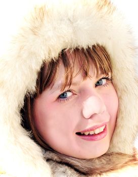 pretty girl with blue eyes is wearing winter fur cap

