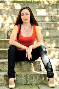 lovely brunette girl sitting on the stairs