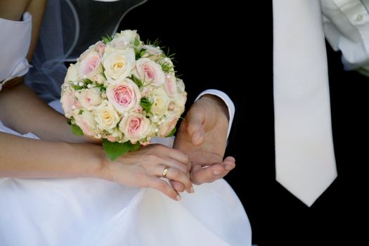 newmarried hands with flowers