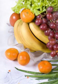 Assorted fresh vegetables and fruits in a vase 