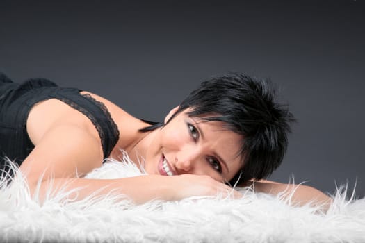 Young woman laying on the bed and smiling