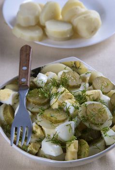 A plate of potato salad layered with hard-boiled eggs