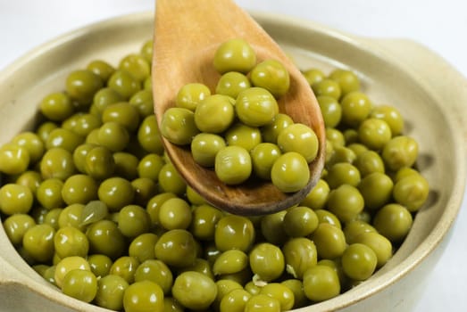 Spoon of green pickle peas
