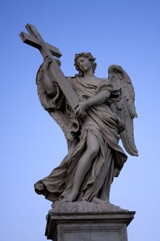 Sculpture of an angel with wings on a background of blue sky