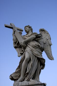 Angel with wings in Rome over blue sky