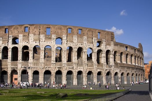 Colloseum with green grass over blue sky