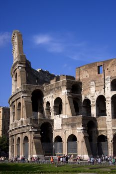 Colosseum in Rome with green grass and people