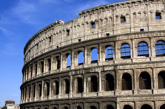 Antique colisseum in Rome over blue sky