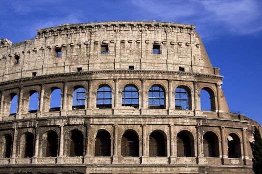 Antique colosseum in Rome over blue sky