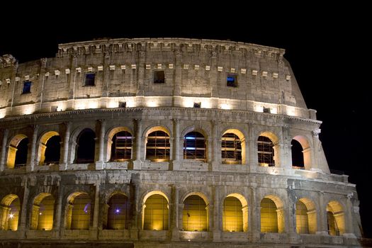 Antique colosseum at night in Rome with lights