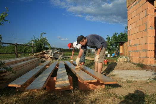 painters painting the wooden logs