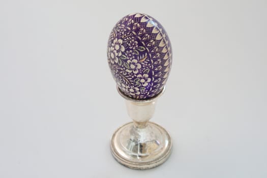 Violet easter egg on white background