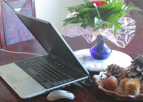 Laptop on the table with flowers