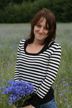 Young woman with flowers, meadow