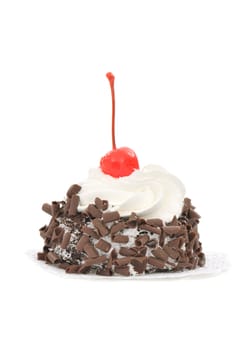 Chocolate cake with cream decorated with a cherry on white background