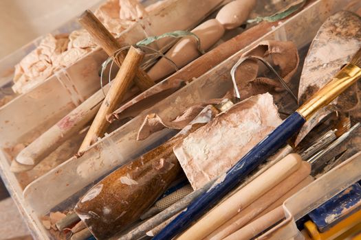 Clay forming implements collected in messy tool kit