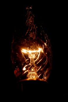 A glowing wolfram thread in a decorative bulb
