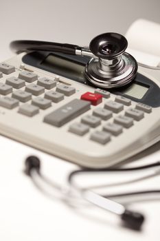 Black Stethoscope on a Calculator with Selective Focus.