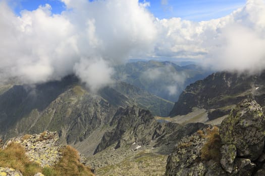 Clouds,rocks and beauty in Fagaras mountains,Romania.In the distance you can se Caltun Lake.The point of view is near the Negoiu summit,which is the second highest mountain top (2635 m) in this mountain range.