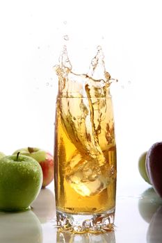 ice cubes falling into a glass of juice