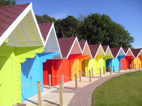 Exteriors of beautiful bright seaside beach chalets, Scarborough, England.