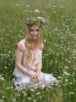 girl in a chaplet from meadow flowers