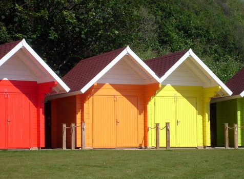 Exteriors of beautiful bright seaside beach chalets, Scarborough, England.