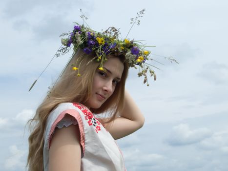 girl in a chaplet from meadow flowers