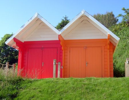 Exteriors of beautiful bright seaside beach chalets, Scarborough, England.