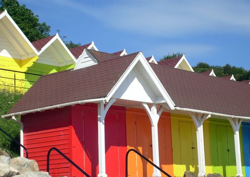 Exteriors of beautiful bright seaside beach chalets, Scarborough, England.