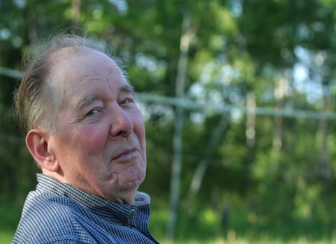 Elderly man enjoying summer outdoors