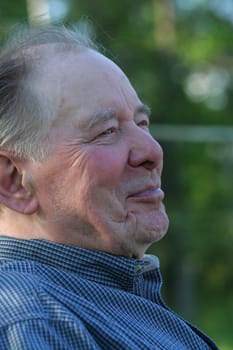 Elderly man enjoying summer outdoors