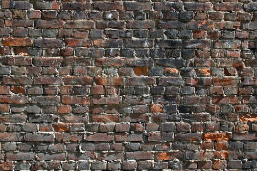 old stained dark brick wall