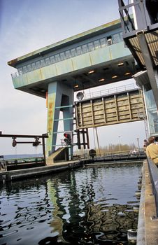 A pleasure boat motors through locks. The inclined plane boat lift at Ronquieres, or sloping lock, raises and lowers boats and barges 68m or 223ft in about 90 minutes on the Brussels - Charleroi canal on a system of rails.
