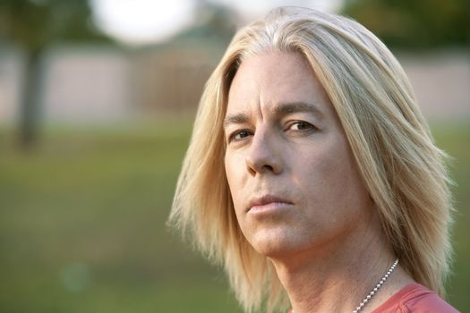 Youthful adult male with long blonde hair