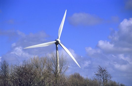 A modern windmill generates power in the Netherlands.