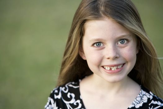 Pretty Young Girl with Freckles and a Big Smile and Crooked Teeth